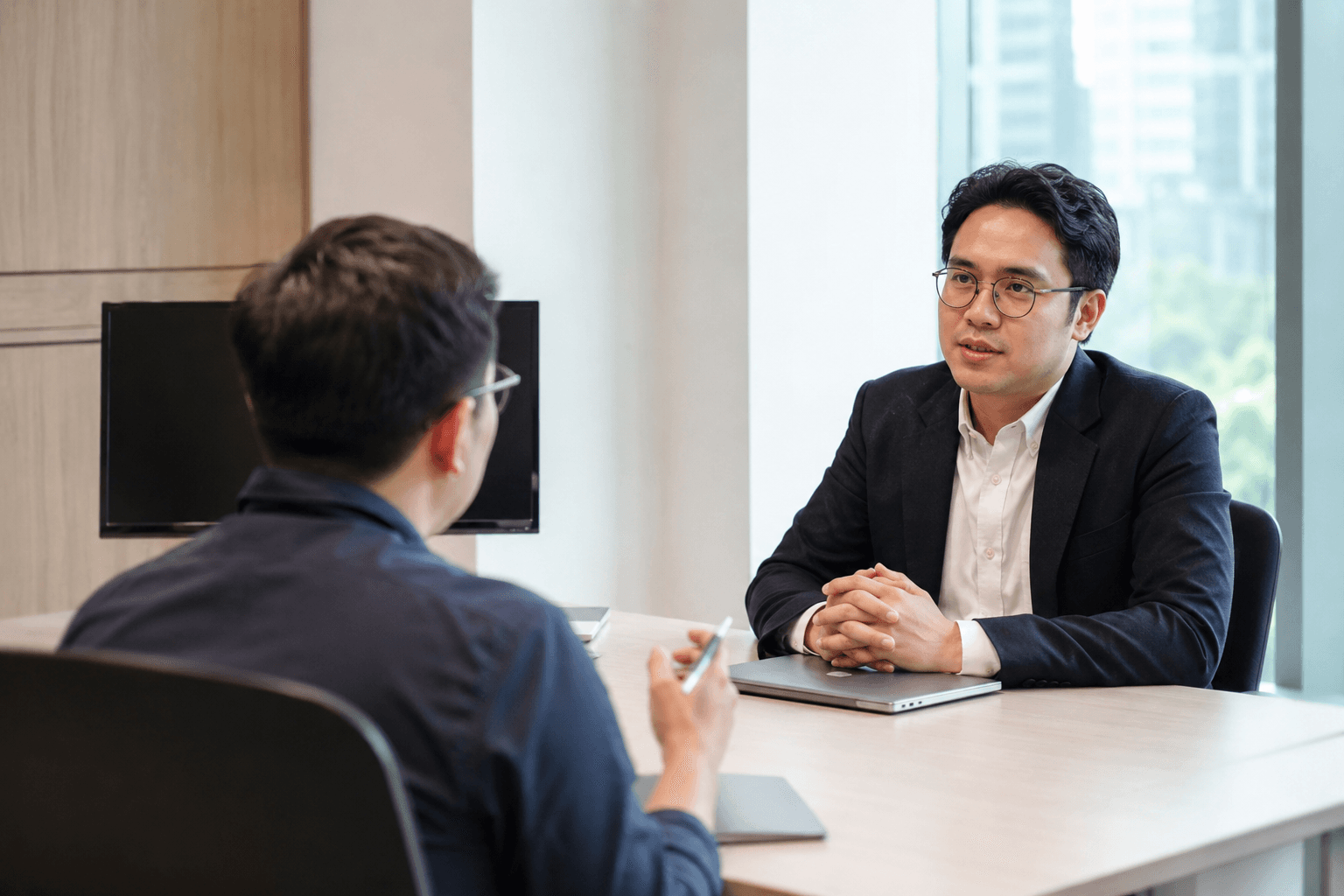 Dua profesional sedang melakukan interview kerja di ruang kantor